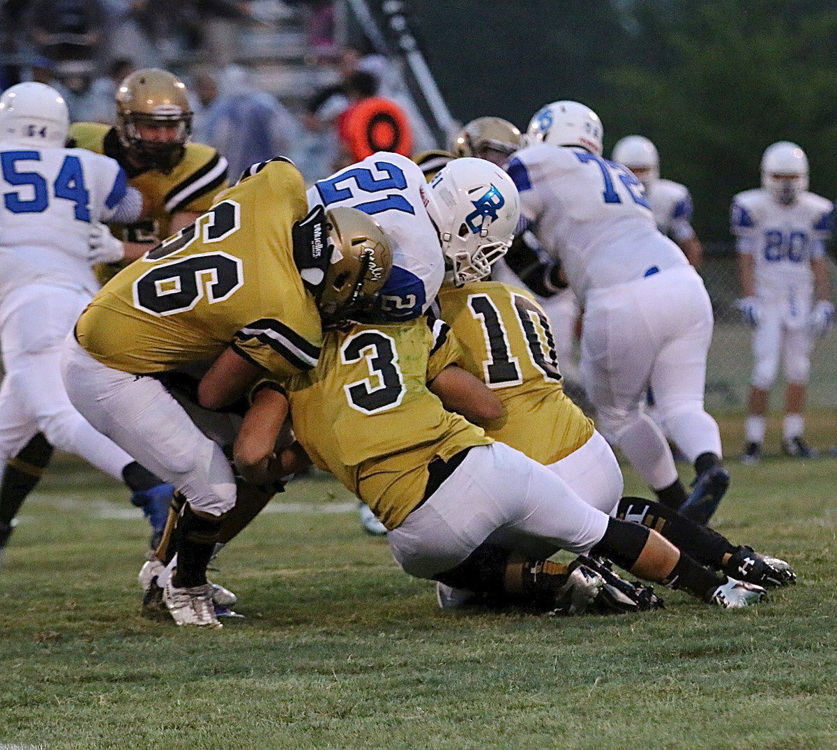 Image: Gladiators Kyle Fortenberry(66), Hunter Merimon(3) and Coby Jeffords(10) combine to bring down a Lion runner with Italy’s defense hustling early.