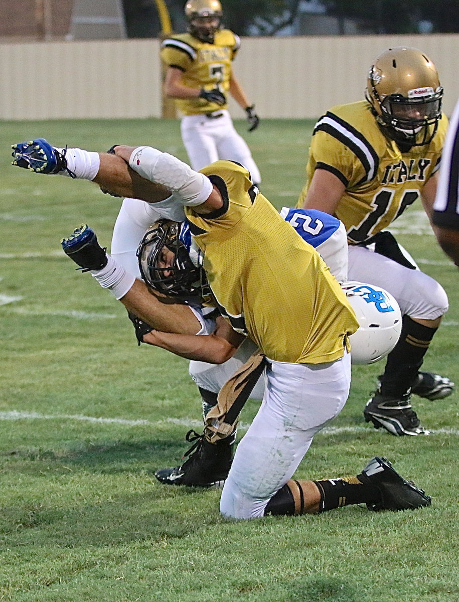 Image: Gladiator Levi McBride(1) upends a Lion ball carrier along Italy’s sideline.