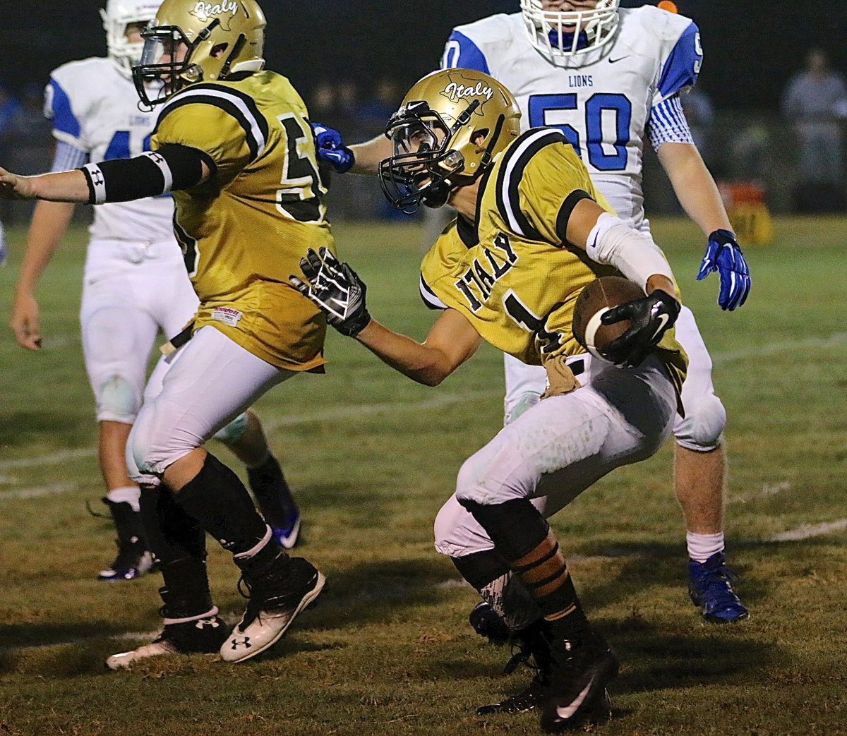 Image: John Escamilla(5) keeps Blooming Grove tacklers back as Levi McBride(1) maneuvers thru the crowd.