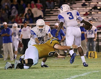 Image: Italy senior defensive end John Byers(60) dives for a Lion leg in the Blooming Grove backfield.