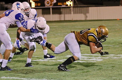 Image: Coby Jeffords(10) crashes thru a cluster of Lion tacklers and then lunges for etxra yards.