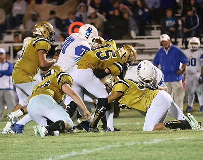 Image: Cody Boyd(15), David DeLaHoya(56), Kyle Fortenberry(66) and Joe Celis(8) converge on a Lion ball carrier.