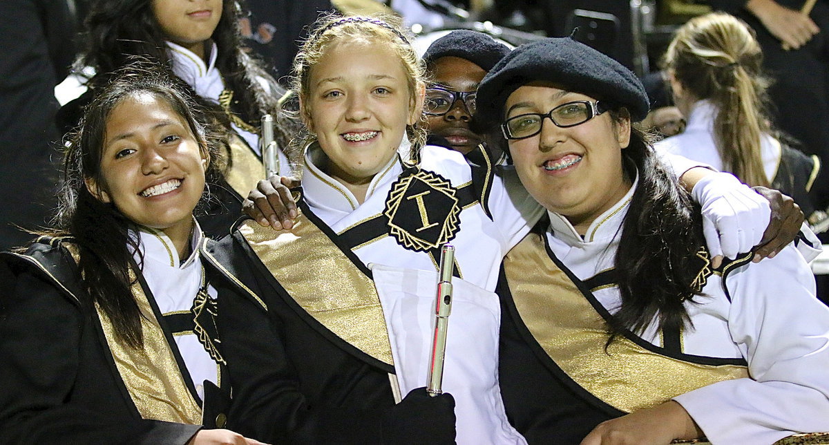 Image: Marlen Hernandez, Brycelen Richards, and Lorena Rodriguez enjoy the game.