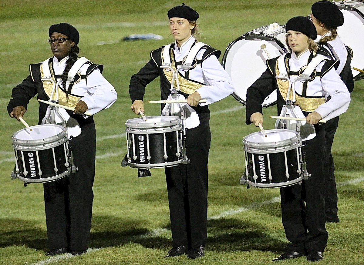 Image: Brenya Williams, Whitney Wolaver and Stockard Smithwick drum up some noise.