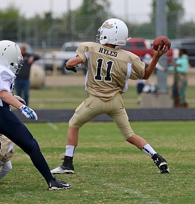 Image: A familiar name: A-team Gladiator Creighton Hyles(11) completes a pass downfield to teammate Kort Holley. Hyles and his younger brother and teammate, Case Hyles(6), continue their family line of great Gladiator athletes.