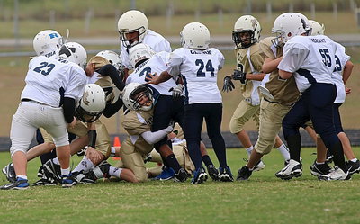 Image: A-team Gladiator Ty Cash(10) makes the tackle against a Rice ball carrier.