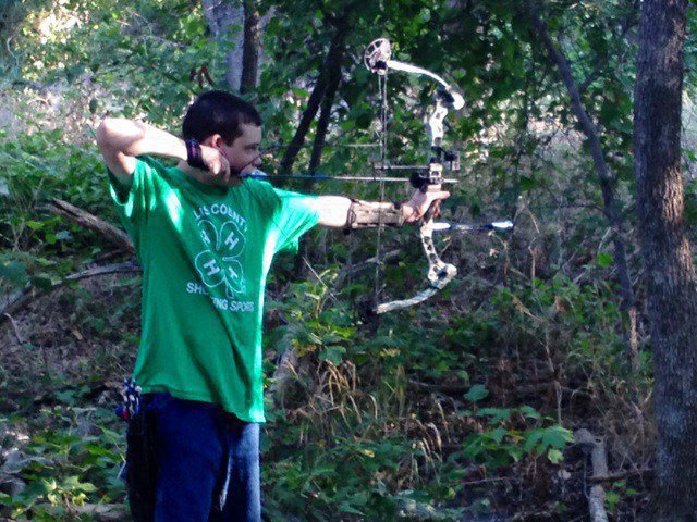 Image: Hunter Hinz takes aim at a 3D target during the Ellis County 4-H Shooting Sports 3D Tournament in Waxahachie.