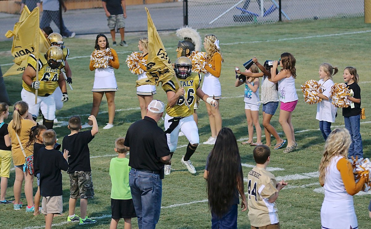 Image: Senior Gladiator Kyle Fortenberry(66) leads the troops onto Willis Field for the district clash with visiting Frost.