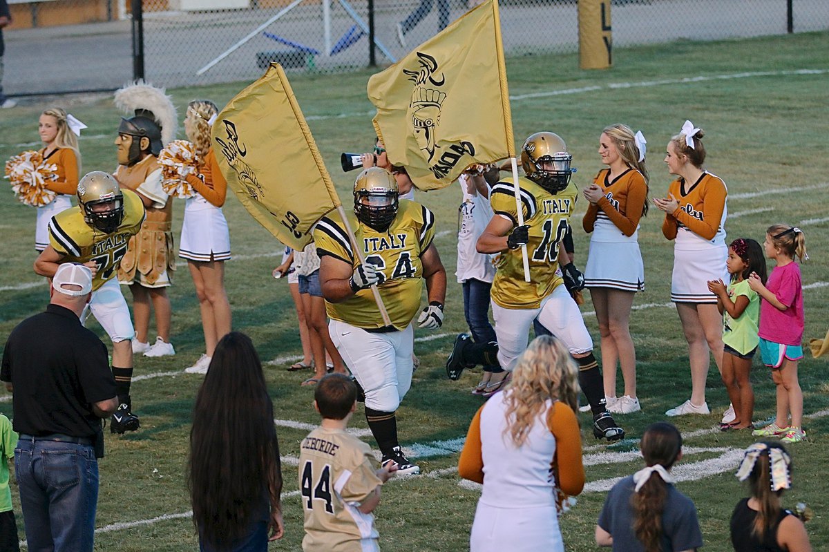 Image: Gladiator Coby Jeffords(10), Ty Fernandez(64) and Clay Riddle(77) hurry out of the tunnel and thru spirit alley.