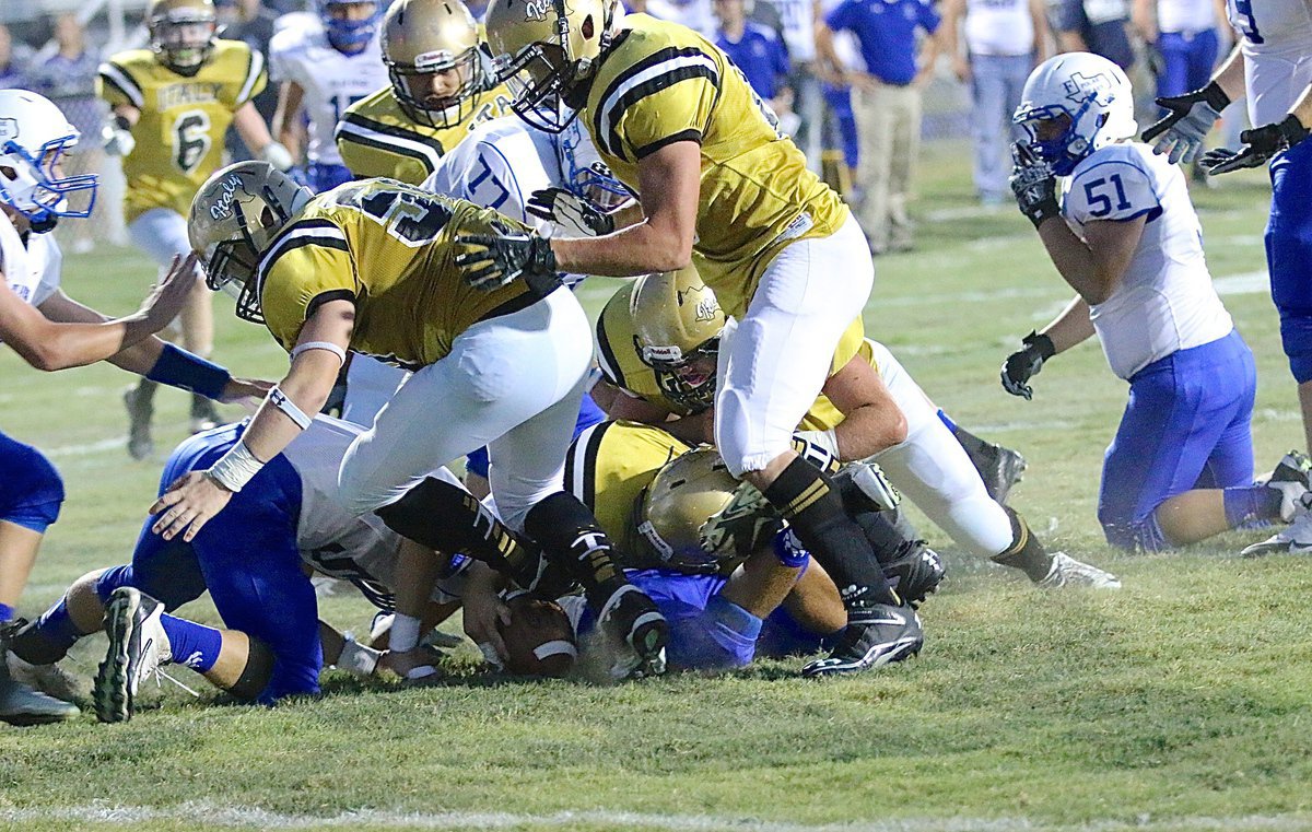 Image: Gladiator defensive tackle Aaron Pittmon(72) gets his paw on the Polar Bear fumble.