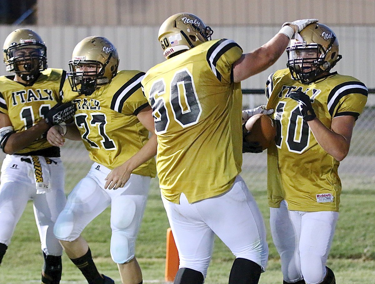 Image: It’s a Celebration! Kendrick Norwood(4), Clay Riddle(77) and John Byers(60) congratulate Coby Jeffords(10) on his first TD of the game and Italy’s first points of the season.