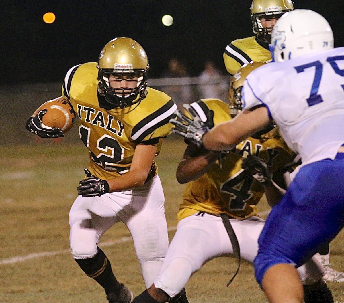 Image: Freshman back Kyle Tindol(12) follows lead blocker Kendrick Norwood(4), also a freshman, outside.