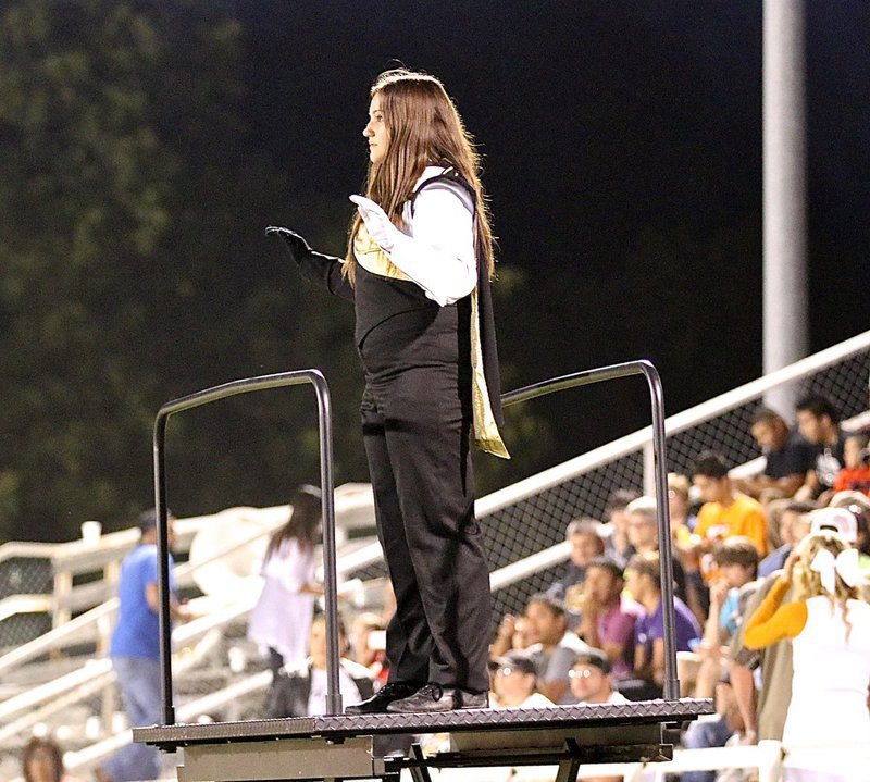 Image: Alexis Sampley leads the band from her post as drum major.