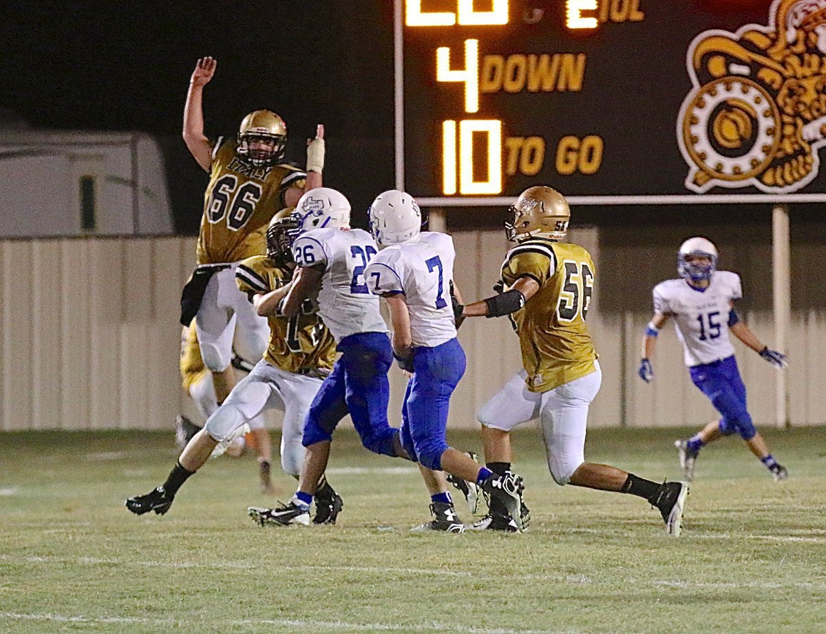 Image: Kyle Fortenberry(66), Clay Riddle(77) and David De La Hoya(56) pressure the Frost quarterback.