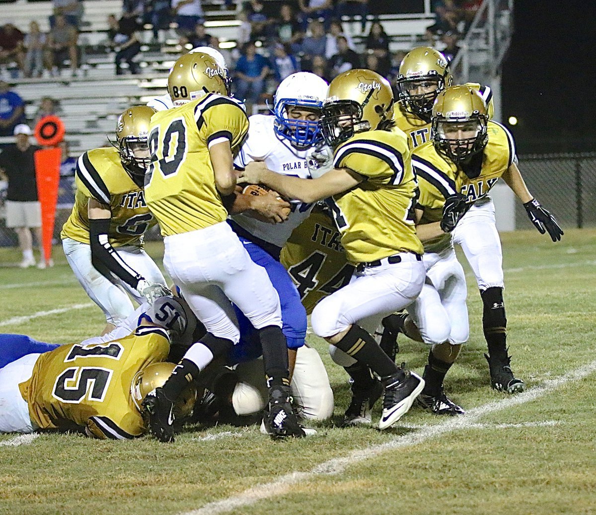 Image: Gladiators Jack Hernandez(80) and Aaron Latimer(21) get a little help from their friends as they swarm a Frost ball carrier.