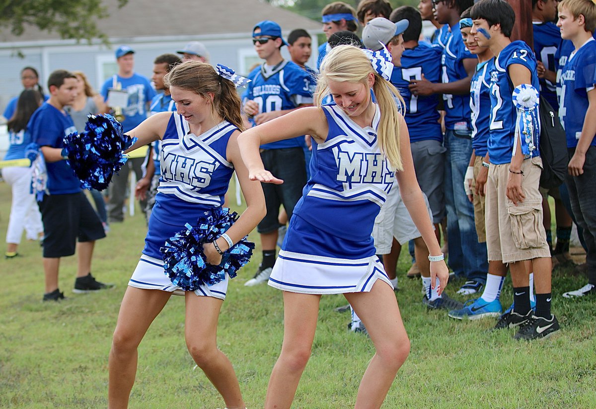 Image: Bulldog Cheerleaders Gabby Rose and Evy Ewing get in the groove during the pep rally in the park.