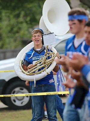 Image: Robbie Johnson(22) is full of team pride with a tuba in one hand and a football in the other.
