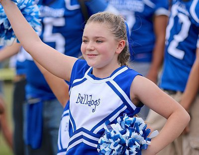 Image: Milford’s pee-wee cheerleader Khrystlyn Wims performs a routine during the pep rally.