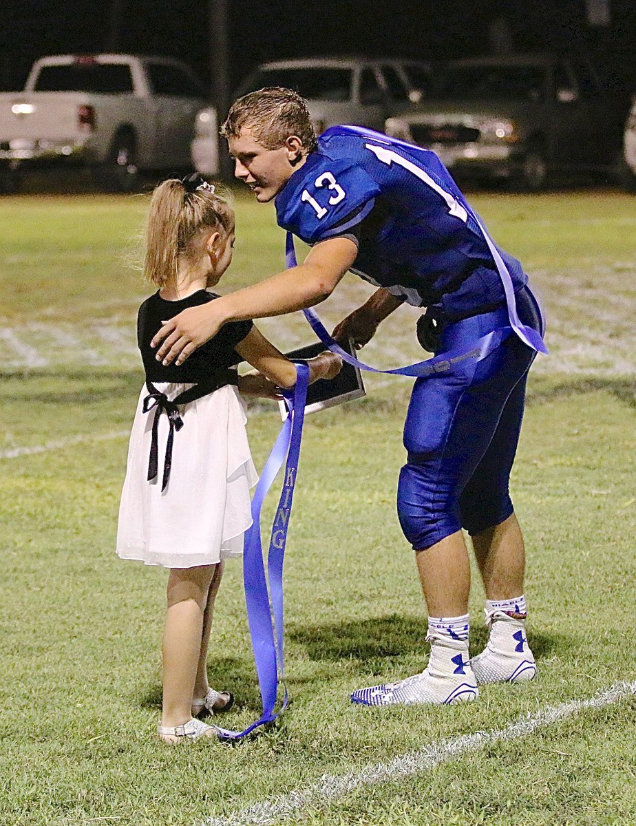 Image: Gracie Jacinto presents Keith Kayser with his Homecoming King plaque.