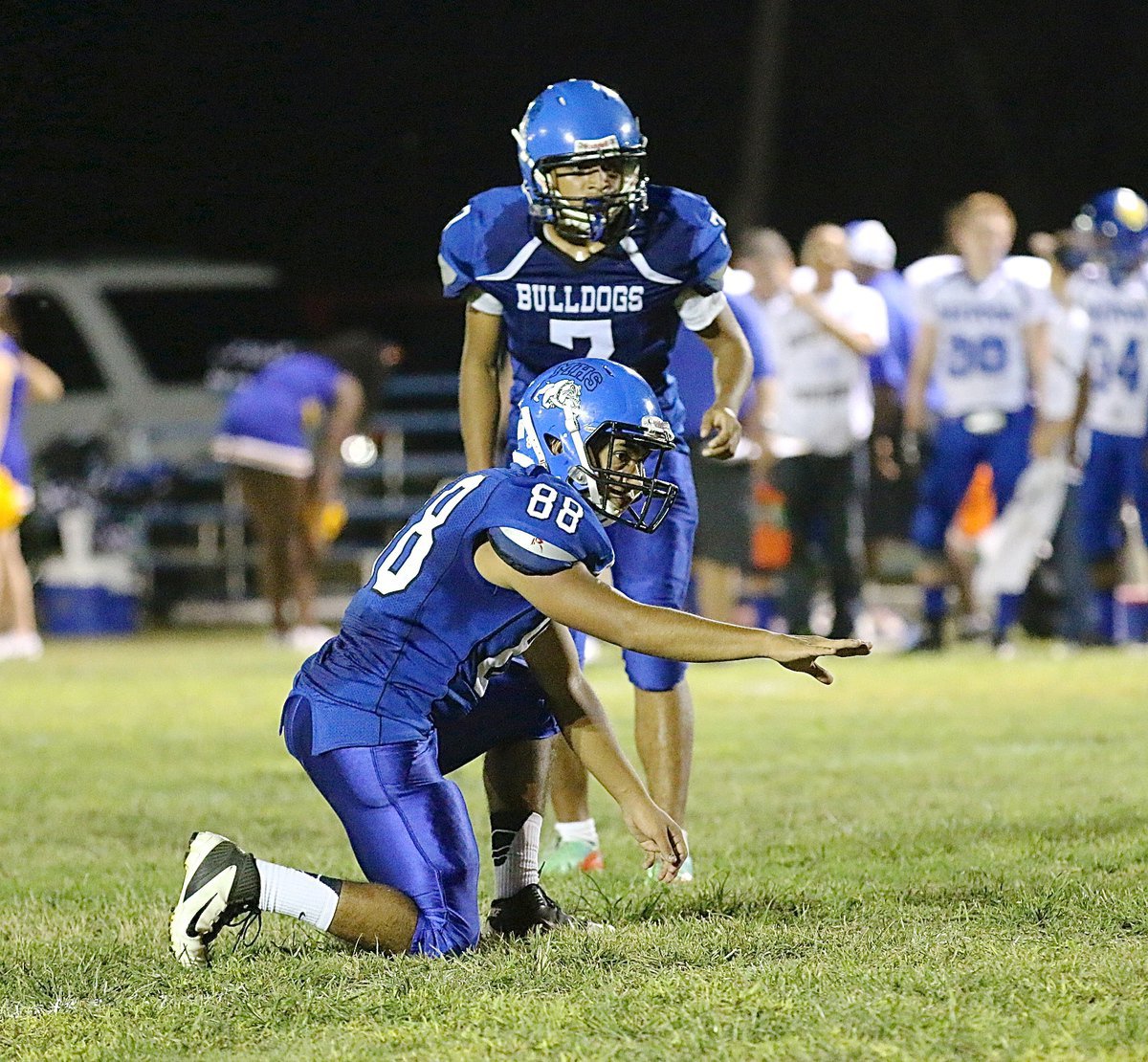 Image: Adrian Ojeda(88) holds for kicker Gerardo Yanez(7).