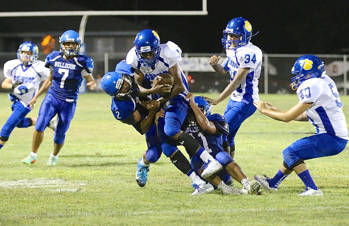 Image: Bulldog defenders TraVion Jones(2) and Jaquay Brown(11) pull down the Oakwood quarterback.