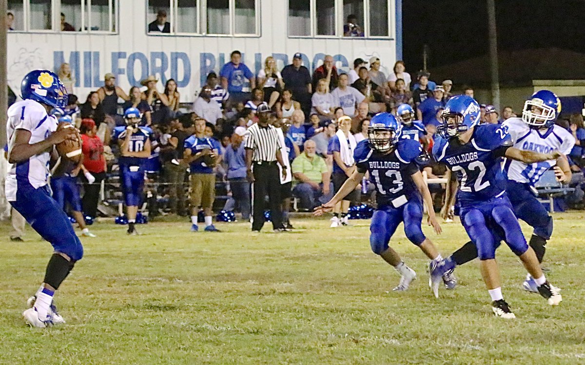 Image: Milford’s Keith Kayser(13) and Robbie Johnson(22) try to cage the Panther QB.