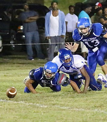 Image: Milford’s Jaquay Brown(11) forces a fumble as he and teammate Keith Kayser(13) try to recover it.