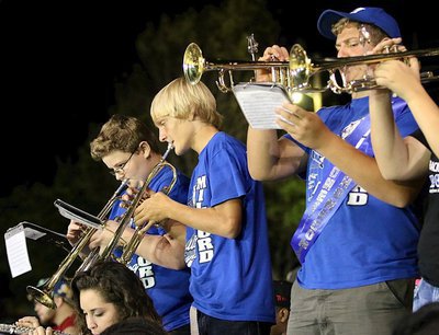 Image: Ryder Tucker (middle) and his band mates make some noise from the bleachers.