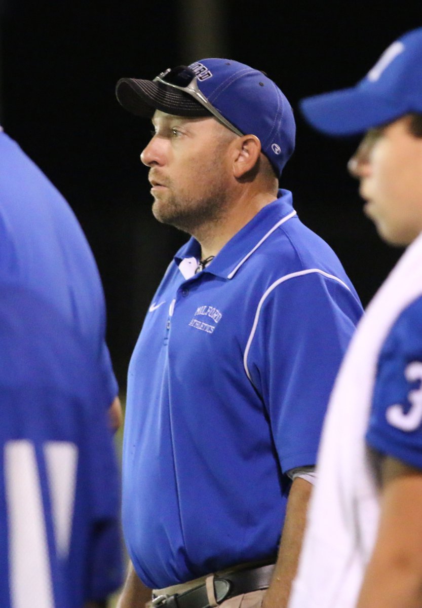 Image: Assistant football coach Joe Stephens is focused on the game.