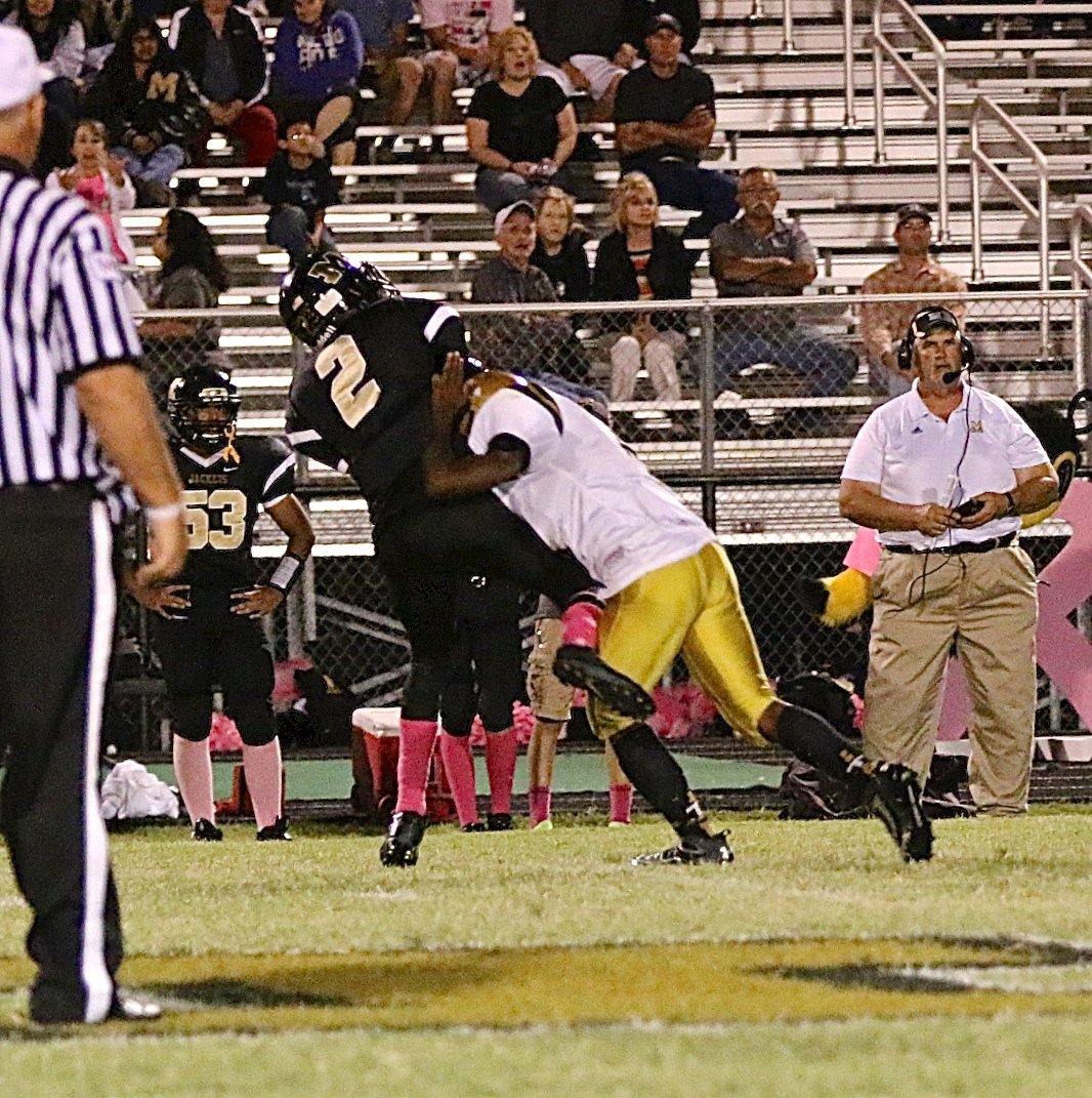 Image: Italy’s Kendrick Norwood(4) gets pressure on the Meridian quarterback.