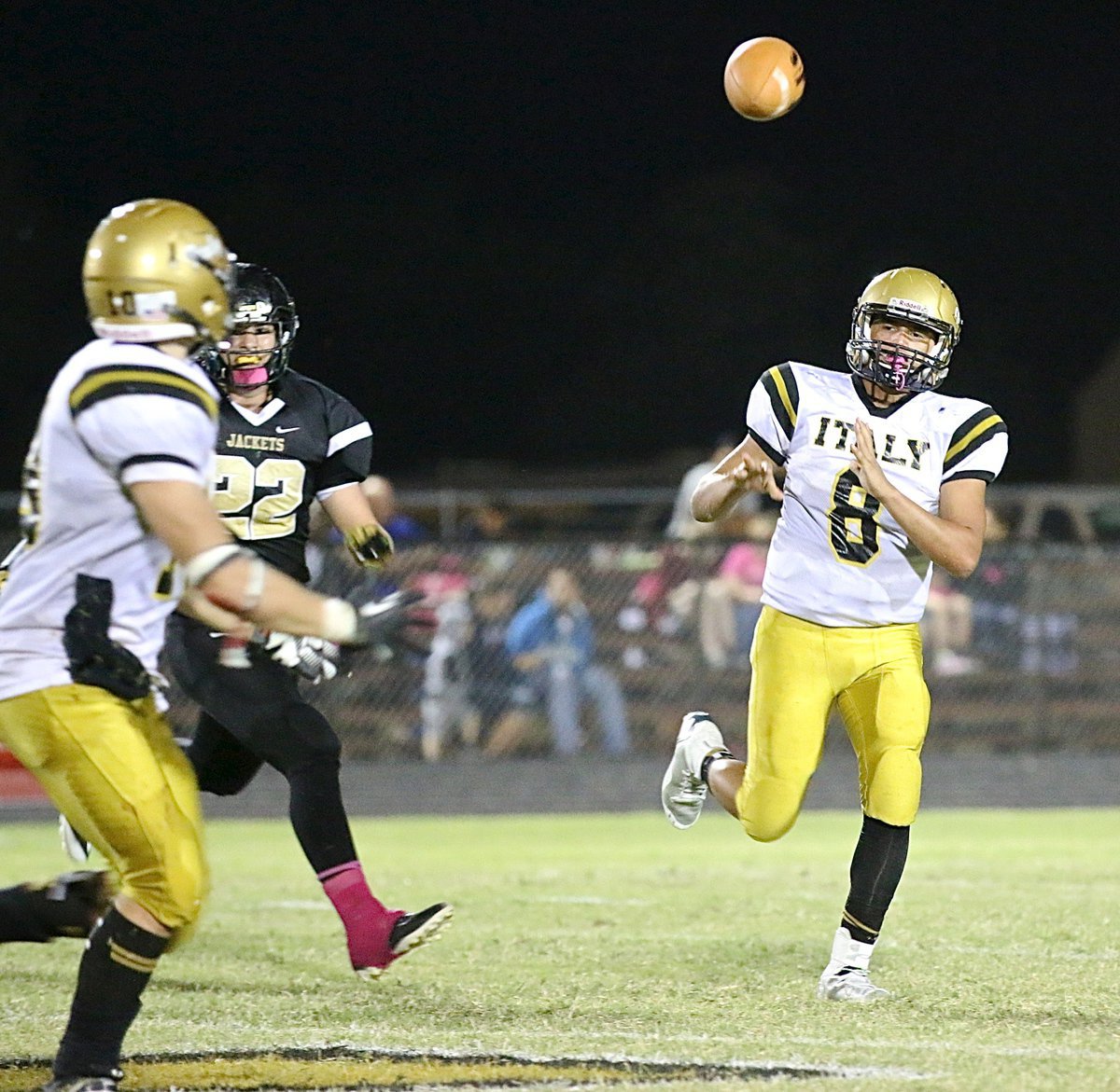 Image: Gladiator quarterback Joe Celis(8) completes a pass to teammate Coby Jeffords(10).