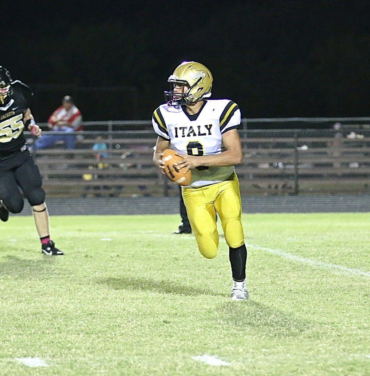 Image: Joe Celis(8) rolls out to pass for the Italy offense.