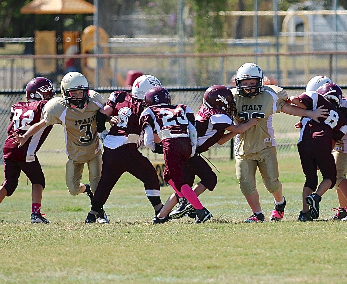 Image: IYAA B-team inside tackles Taylor Sparks(3) and Bryce Ballard(30) explode thru the gaps of Mildred’s offensive line.