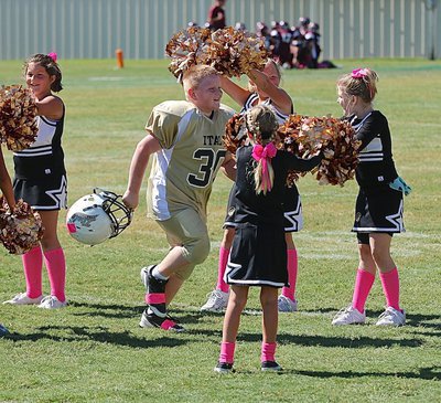 Image: Bryce Ballard(30) is unable to contain his smile as he takes a victory lap thru spirit alley. Thanks cheerleaders!