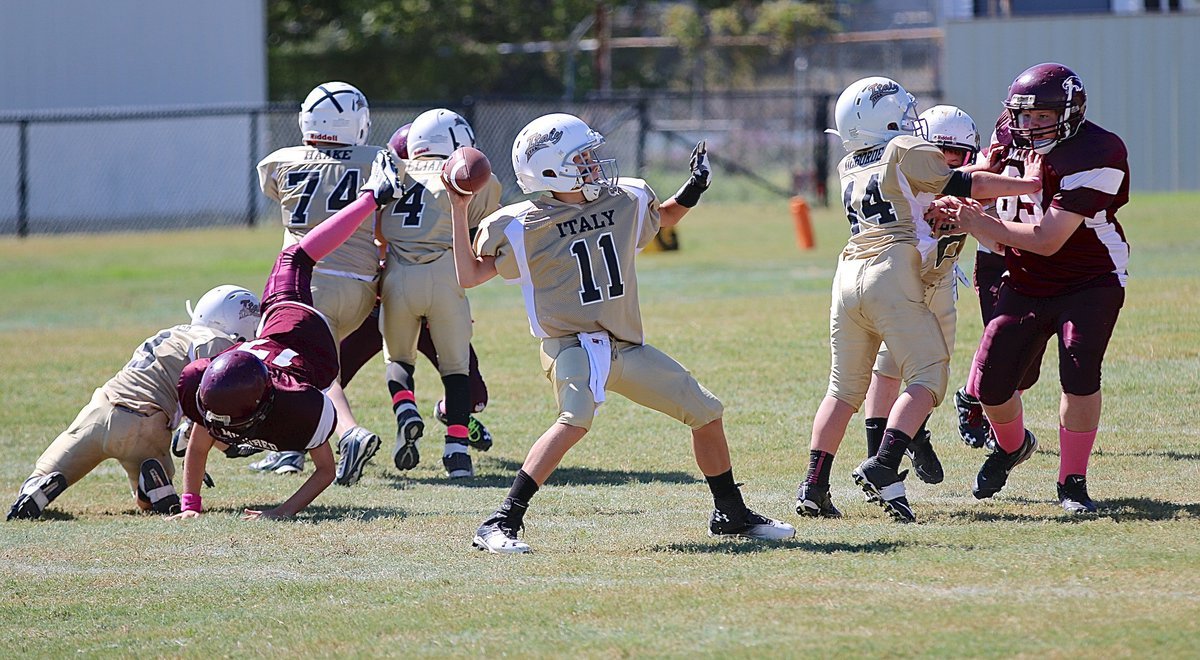 Image: Quarterback Creighton Hyles(11) sets up in the pocket and completes a pass downfield for the IYAA A-team.