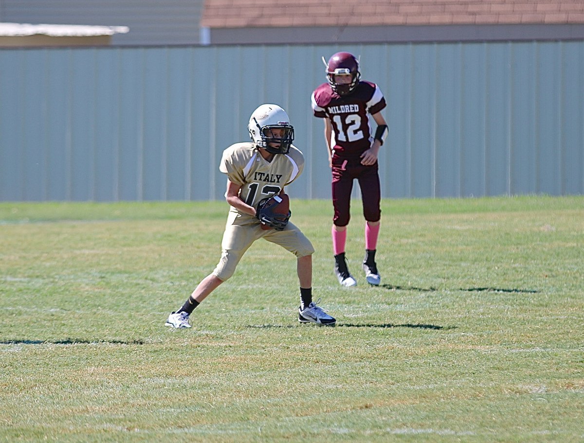 Image: A-team Gladiator Reece Janek(12) makes the catch and then breaks tackles to get the ball into scoring position.