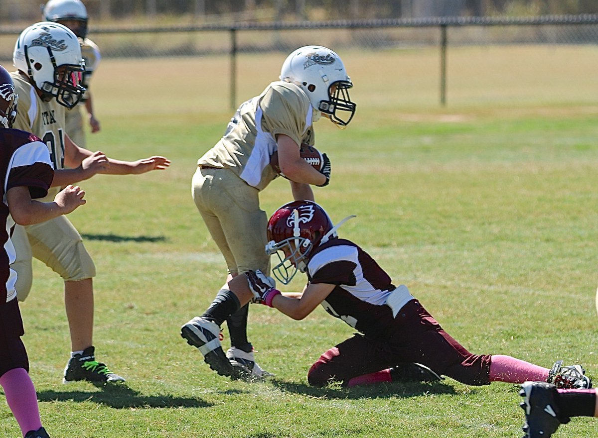 Image: A-team ball carrier Ty Cash(3) rumbles his way forward as he breaks a tackle to pick up more yards.