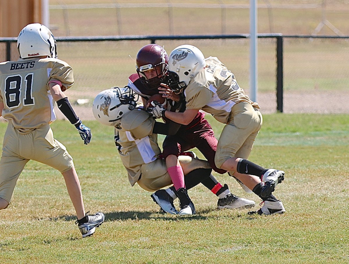 Image: A-team Gladiator defenders Julius Williams(4) and Ty Cash(3) nearly get a defensive safety but the ball is ruled down at the 1-yard line.