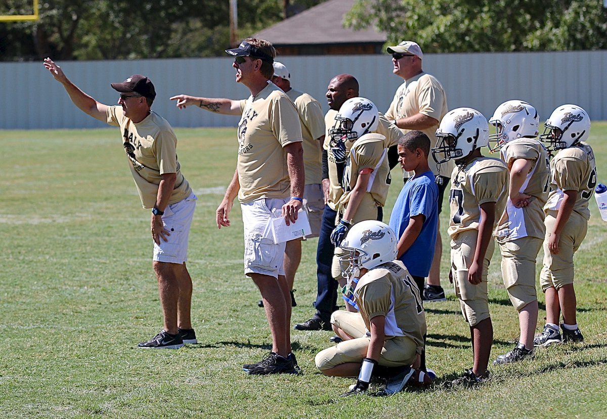 Image: IYAA A-team coaches communicate with their players from the sideline.