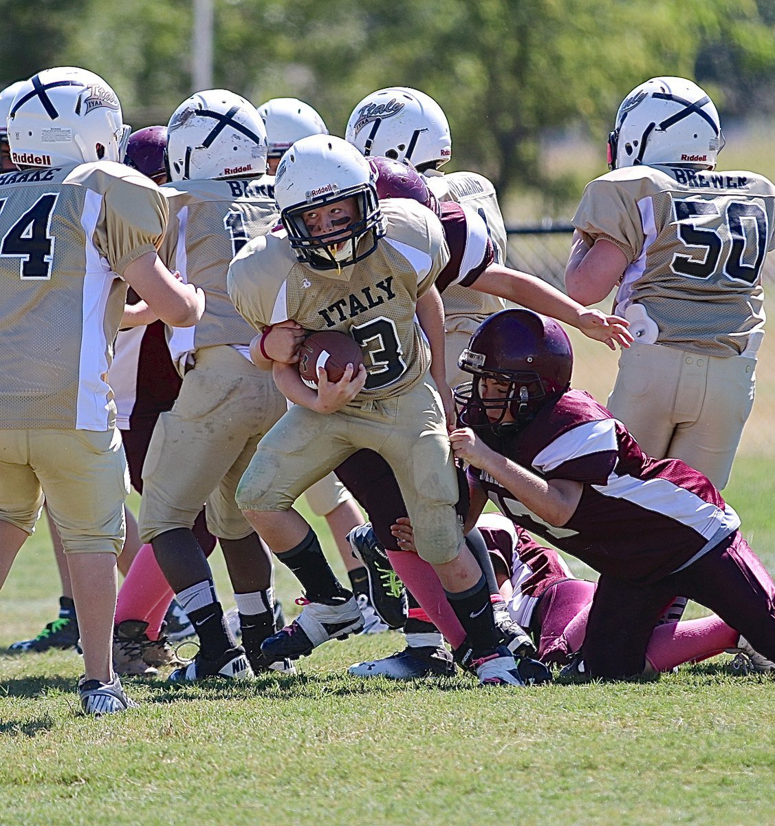 Image: Ty Cash(3) fights thru a couple of Mildred tacklers for Italy’s A-team offense.