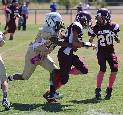 Image: A-Team Gladiator Jayden Barr(14) catches a Mildred Eagle ball carrier from behind.
