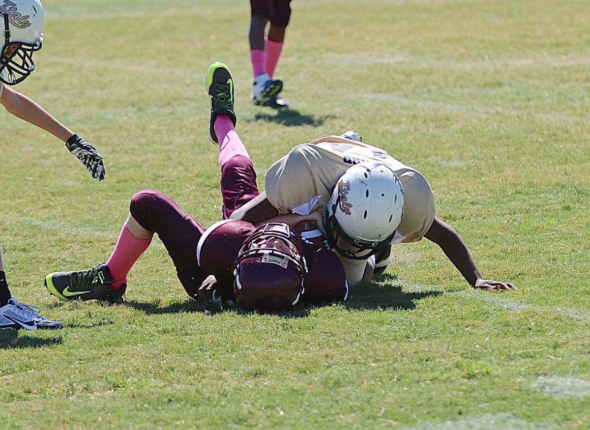 Image: With authority!!! A-team Gladiator Jayden Barr(14) slams down a Mildred Eagle running back.