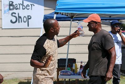 Image: Leroy “June” Johnson gets in the groove outside the Dynamic Kut’z barber shop in Italy as part of Customer Appreciation Day as “Bo Bo”  heads toward the grill and Johnny “King Rap J” Johnson performs for the DK customers.