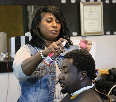 Image: Dynamic Kut’z owner Cynthia Singleton Chance trims and styles the hair of Sean Brooks during Customer Appreciation Day.