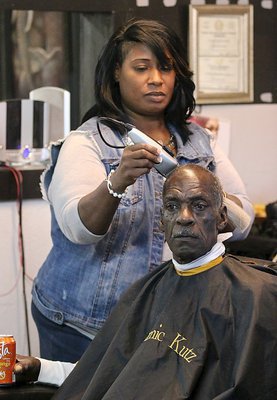 Image: Dynamic Kut’z owner Cynthia Singleton Chance gives Paul Elliott a haircut during Customer Appreciation Day at her Barber shop located in Italy, Texas.
