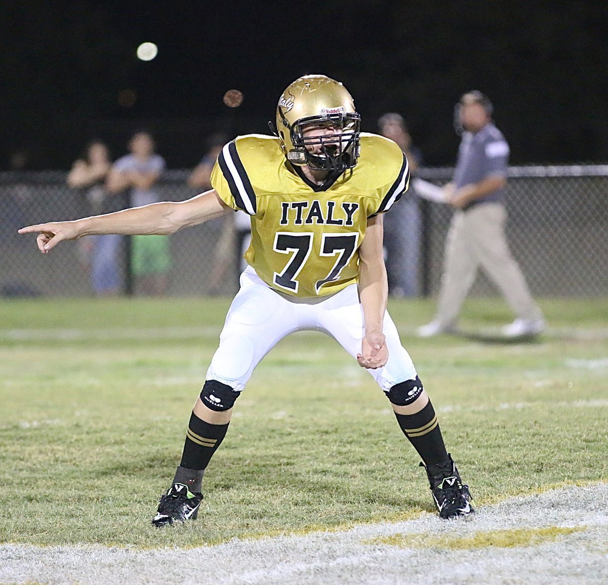 Image: Freshman Clay Riddle(77) directs the front soldiers of the Gladiator kickoff return team.