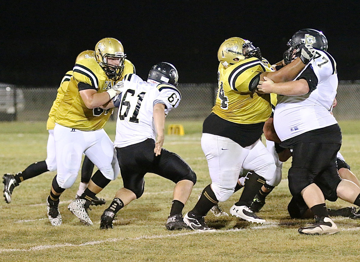 Image: Senior offensive linemen John Byers(60) and Ty Fernandez(64) manhandle the Dawson defensive front.