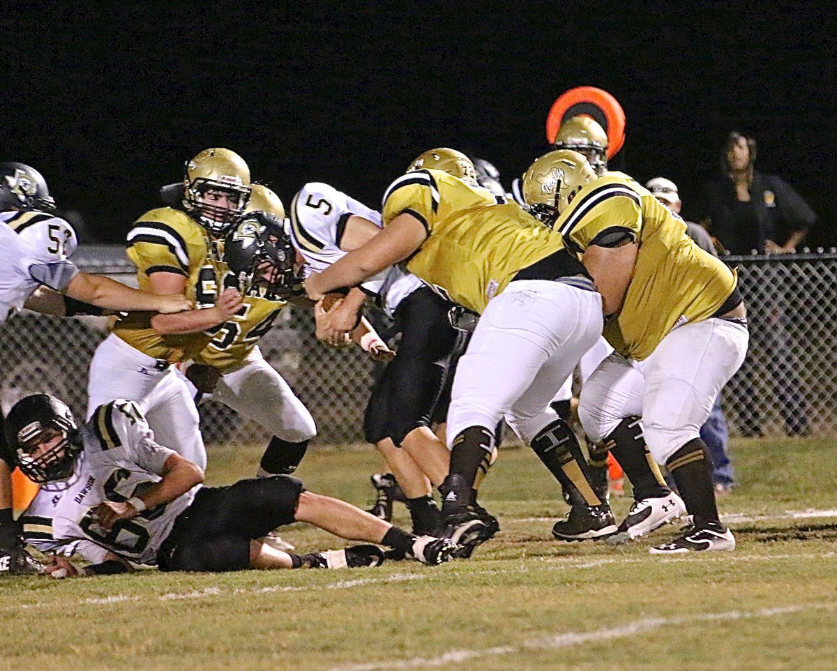 Image: Gladiator defensive tackle, Aaron Pittmon(72) wraps up a Dawson running back with help from teammates Ty Fernandez(64) and Kyle Fortenberry(66).