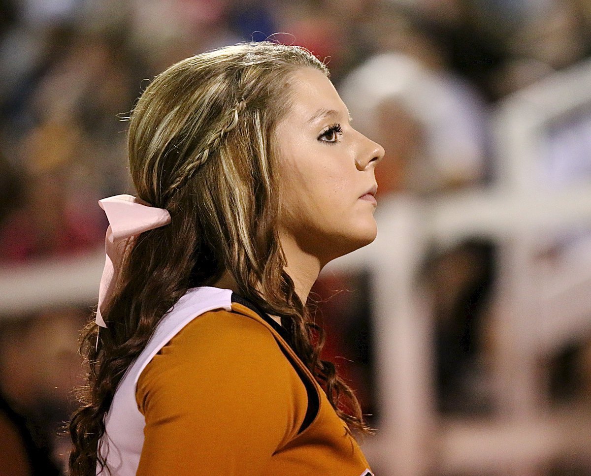 Image: Italy High School cheerleader Brooke DeBorde crowd watches from the sideline.