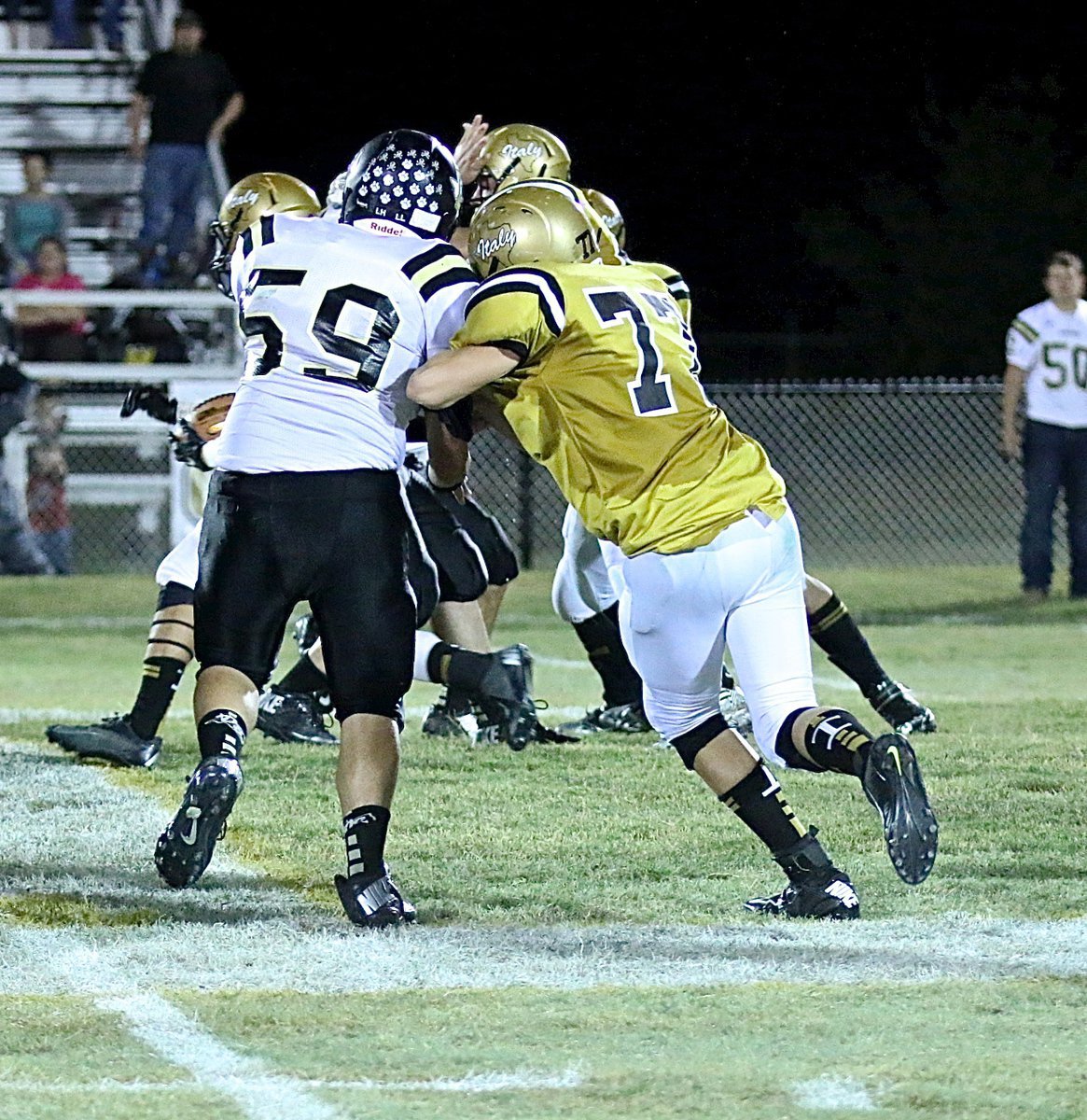 Image: Offensive guard Clay Riddle(77) stays on his block as the ball crosses midfield.